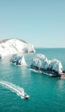 Aerial view of white rock formations standing tall from sea