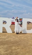 Woman standing in front of Black Pride sign