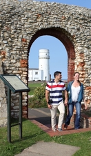 Two people stood outside Hunstanton chapel with the lighthouse in the background