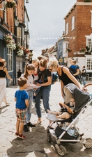 A family looking at a map on a street on Castle Hill in Lincoln