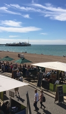 A view above Lucky Beach Café on Brighton beach with views of the pier behind