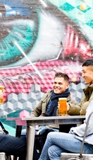 Group of friends at Fargo village featuring artworks by artists Snub23 and My Dog Sighs. Coventry, West Midlands, England