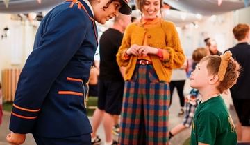 Character actors talking to a young child.