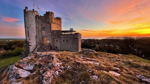 The sun setting behind Roch Castle in Wales.