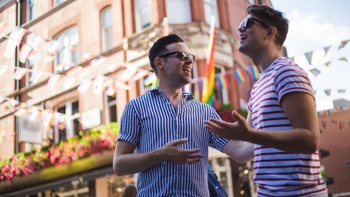Young men talk outside a bar