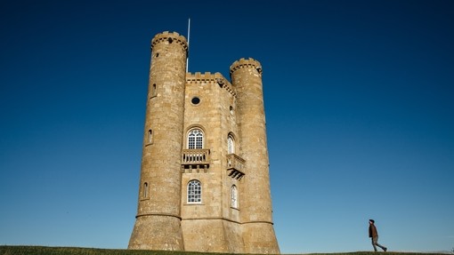Man walking towards Broadway Tower, Broadway, Cotswolds, Worcestershire, England, UK.