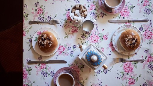High angle close up of tea and buns on a table