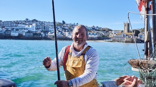 Fisherman in his fishing boat in the harbour