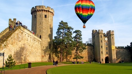 A hot air balloon floats over Warwick Castle in Warwickshire, England.