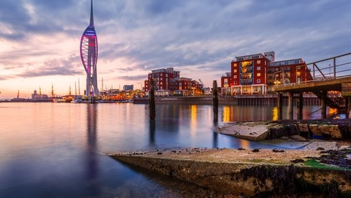 Portsmouth Harbour with Spinnaker Tower lit up at dusk