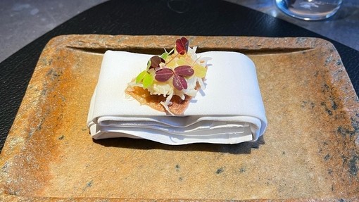 A plate of prepared food sitting on a table in Aulis, London