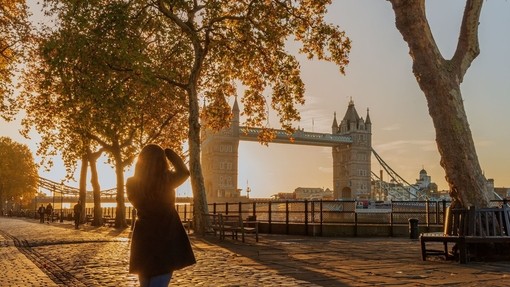 Woman looking at Tower Bridge from Tower Wharf