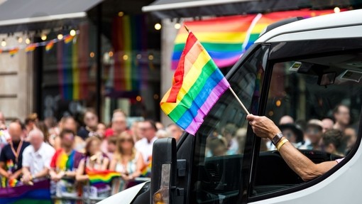 Crowds of people celebrating at the London Pride parade in the city centre.