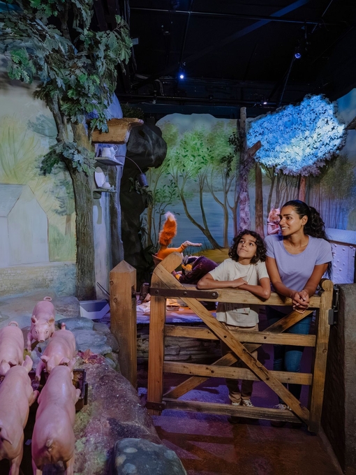 Mother and son looking around at a rabbit themed exhibition.