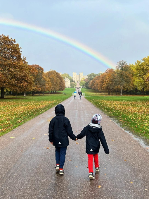 A couple walking towards Windsor Castle on the Long Walk in the Great Park