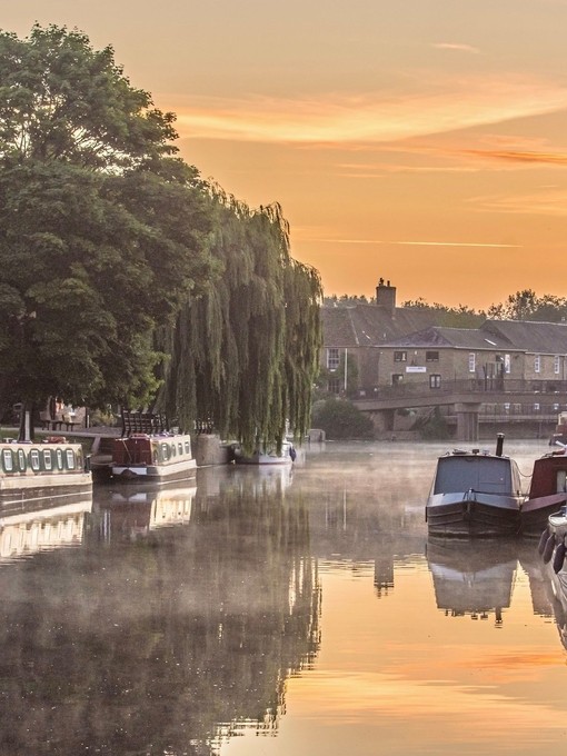 Canal boats moored along the River Great Ouse in Ely