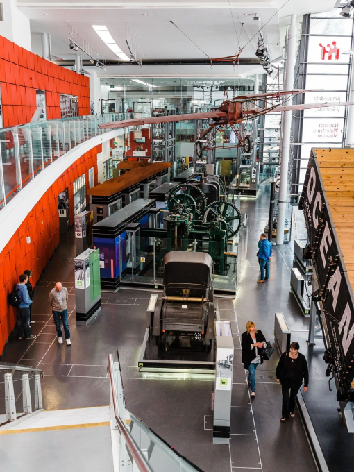 People walking through an exhibit at a modern museum.
