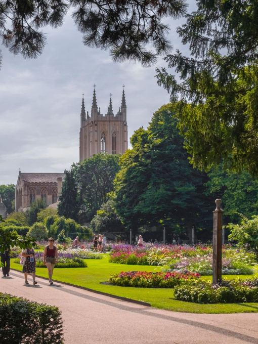 A cathedral amongst manicured gardens on a summer's day