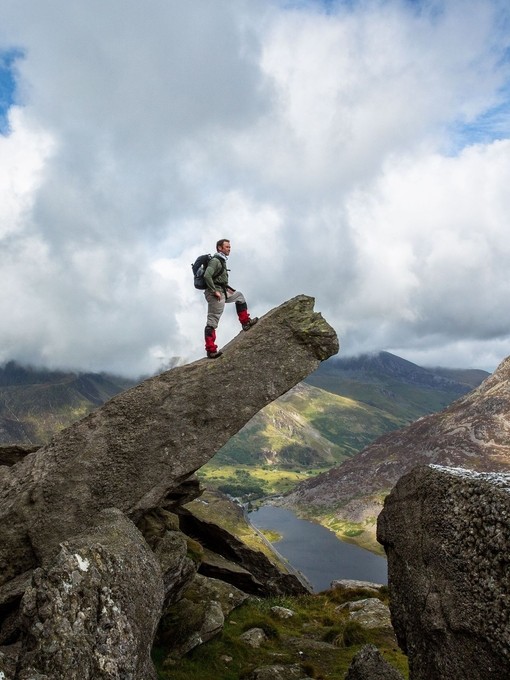 Male hiker admiring view from a pinnacle rock formation