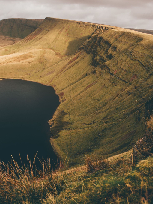 A reservoir surrounded by hills in a countryside landscape.