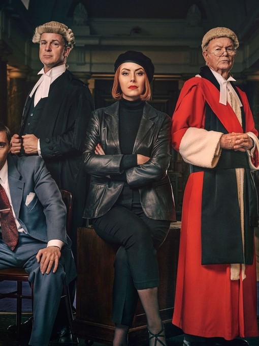 Actors in legal costume ready to perform a play in front of an audience.