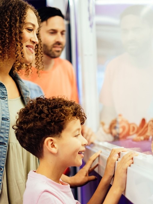 A young boy, with parents, looking at a chocolate display