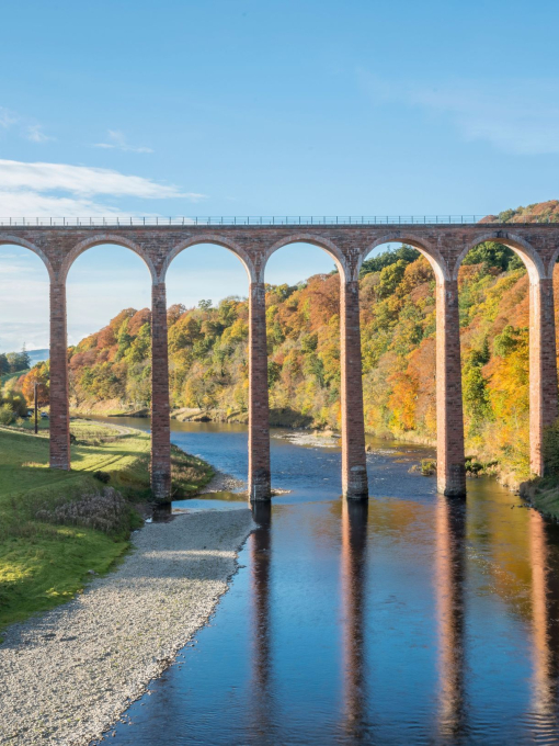 A railway viaduct crossing a river.