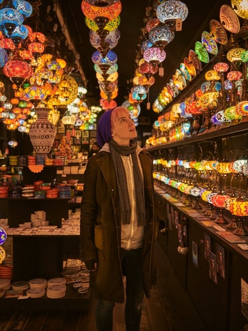 One young woman standing in a lighting shop