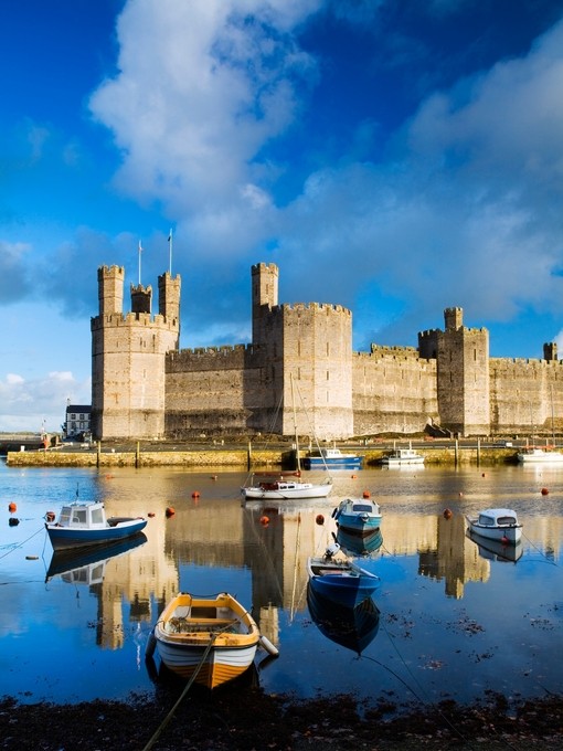 Row boats in a moat surrounding a castle