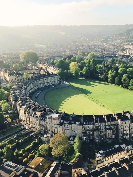 Aerial view of crescent-shaped building surrounded by grass