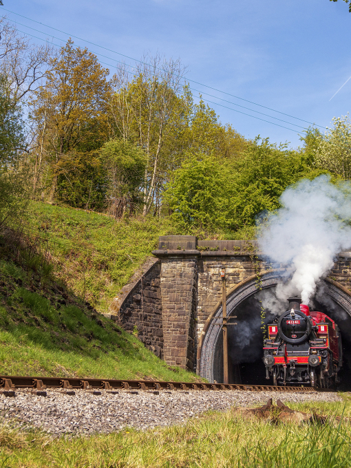 Steam train emerging from Mytholmes Tunnel, Keighley and Worth Valley Railway
