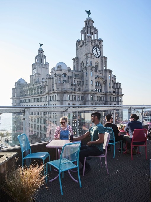 Rooftop terrace restaurant with expansive city views.