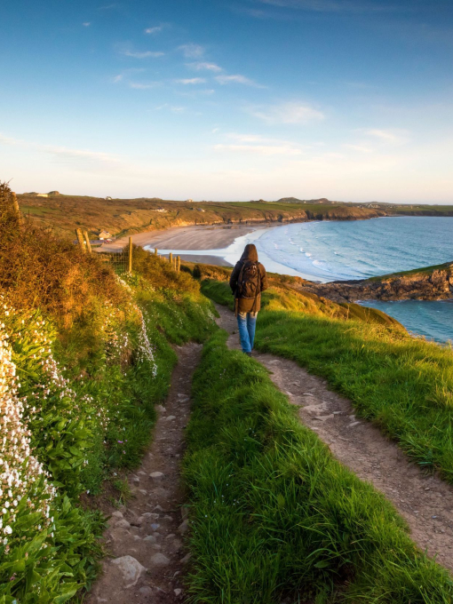 Walker on the Pembrokeshire coast path at Whitesands near St Davids, Wales