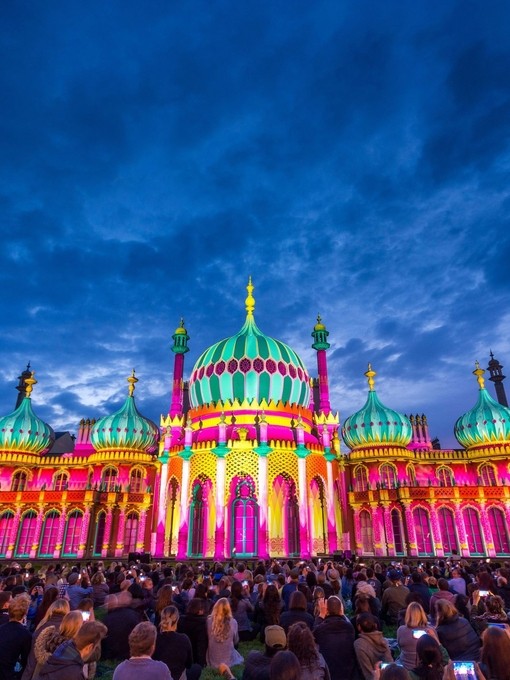 Royal Pavilion at dusk, lit up in a range of vivid colours