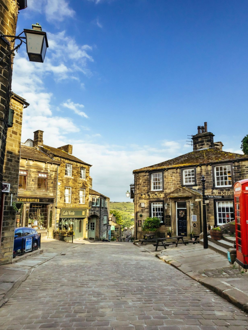 A view down a traditional cobbled street with a telephone box in view