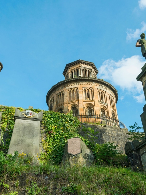 Old building with gravestones in foreground