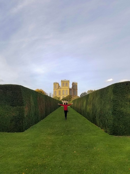 Woman stands in the garden of Hardwick Hall