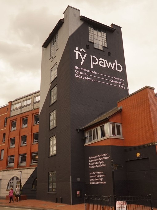 Exterior view of a building with a sign that reads 'Ty Pawb'.