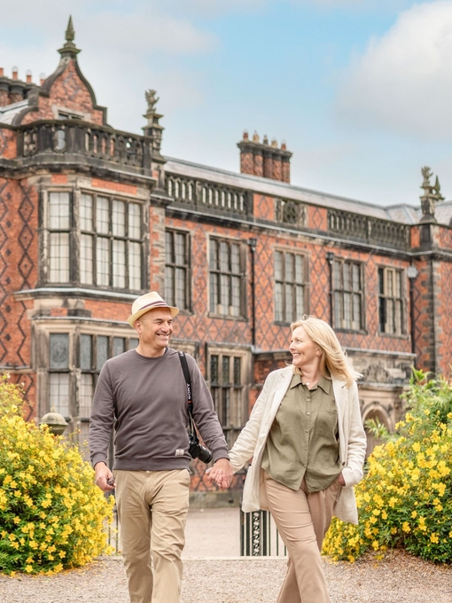 A man and a woman walk through the grounds of a heritage property