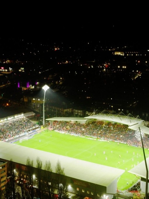 A packed football stadium at night