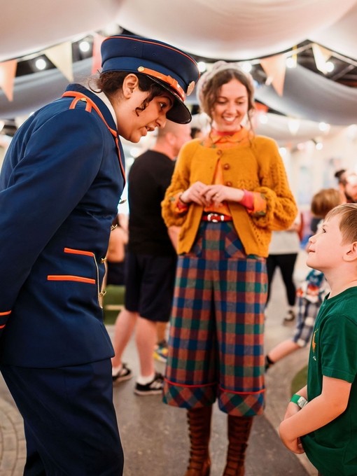 Character actors talking to a young child.