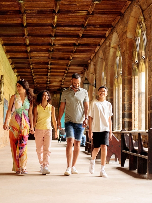 Family walking through the cloisters of a cathedral