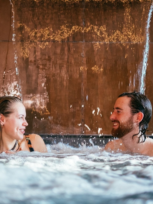 A couple in a pool as part of a spa treatment at Wave Garden Spa