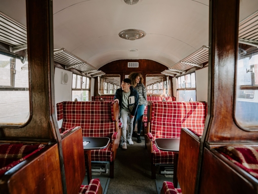 A man and a woman inside a train carriage.