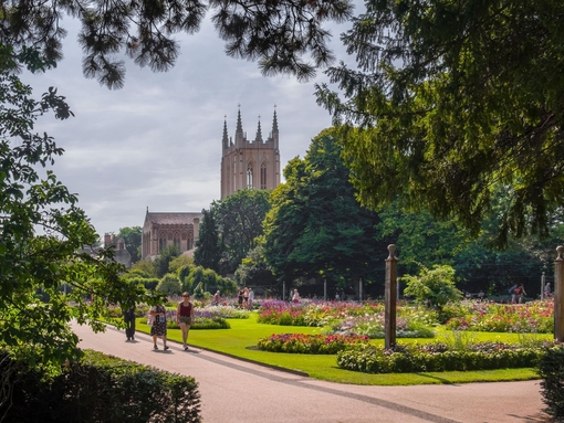 A cathedral amongst manicured gardens on a summer's day