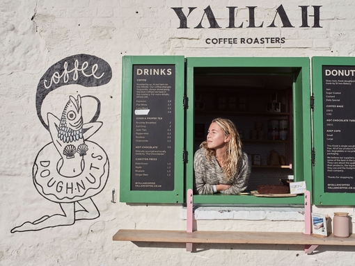 Women looking through shop window of a coffee shop