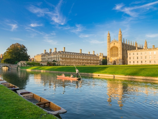 View of college in Cambridge with people punting on River 