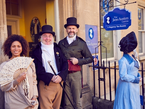 Visitors and staff in period costume outside The Jane Austen Centre, Bath, Somerset, England