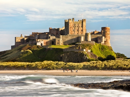 View from a distance of a castle on hill near a beach