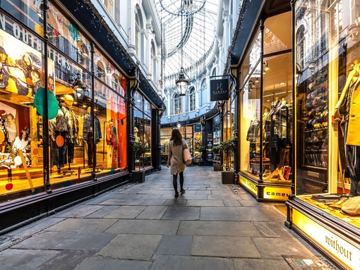 People walking between shops, lit up from inside